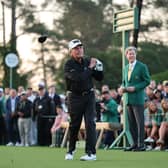 Honorary Starter Gary Player of South Africa plays his shot from the first tee at Augusta National Golf Club watched by Masters chairman Fred Ridley 