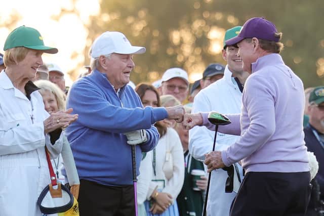 Honorary Starters Jack Nicklaus and Tom Watson fist bump after hitting their tee shots at Augusta National Golf Club