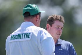 Bob MacIntyre interacts with caddie Mike Burrow on the 18th green during the first round of the 2025 Masters Tournament at Augusta National Golf Club