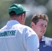 Bob MacIntyre interacts with caddie Mike Burrow on the 18th green during the first round of the 2025 Masters Tournament at Augusta National Golf Club
