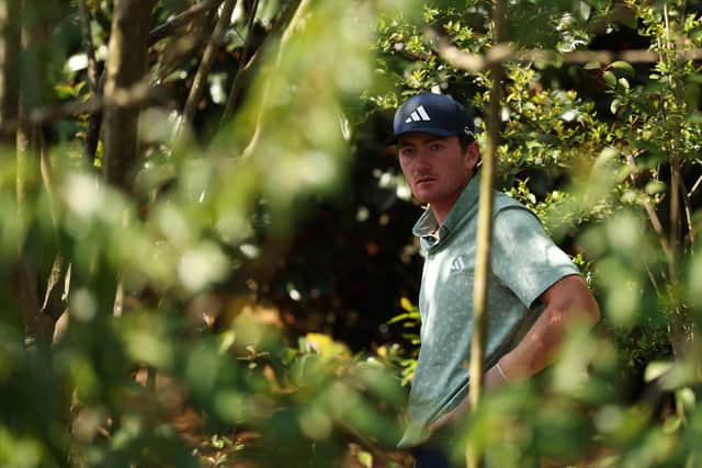 American Nick Dunlap in the trees on the fifth hole during the first round 