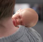 Baby Amy Isabel, seen on her father Angus Davidson's shoulder, was born after her mother, Grace Davidson, had a womb transplant (Picture: Womb Transplant UK)