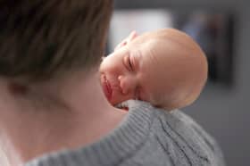 Baby Amy Isabel, seen on her father Angus Davidson's shoulder, was born after her mother, Grace Davidson, had a womb transplant (Picture: Womb Transplant UK)