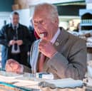 King Charles tries a sheep's milk cheese called Love Ewe at Tebay Services on the southbound carriageway of the M6 (Picture: Arthur Edwards)