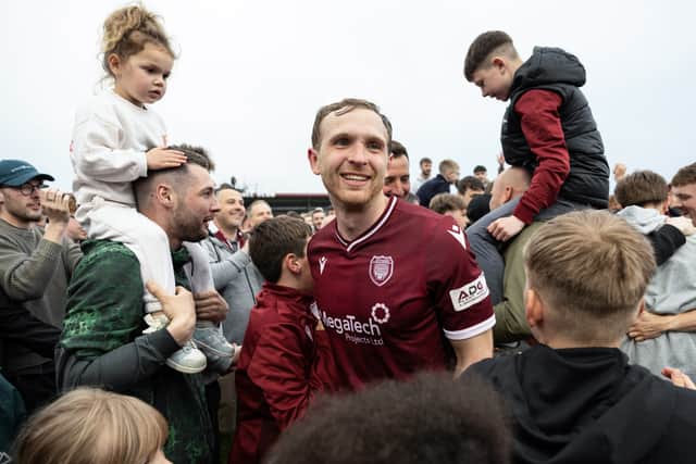 Arbroath's Scott Stewart celebrates at full time with the club's supporters.