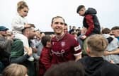 Arbroath's Scott Stewart celebrates at full time with the club's supporters.