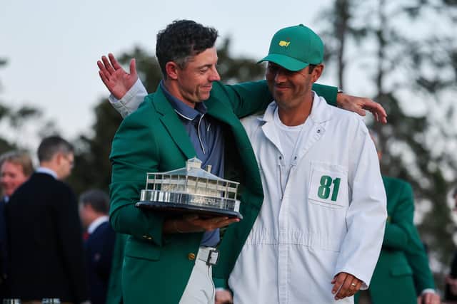 Rory McIlroy celebrates with caddie Harry Diamond after winning the 89th Masters 
