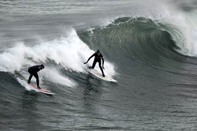 Surfers harness wave power in their own way at Coldingham Bay (Picture: Jeff J Mitchell)