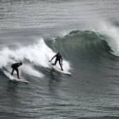 Surfers harness wave power in their own way at Coldingham Bay (Picture: Jeff J Mitchell)