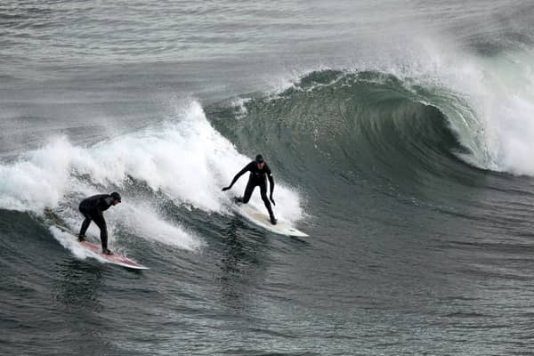 Surfers harness wave power in their own way at Coldingham Bay (Picture: Jeff J Mitchell)