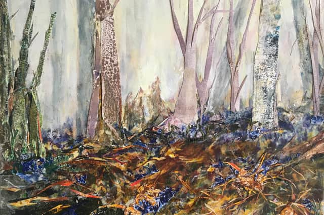 In Annie Broadley's painting 'Roots', bluebells grow in a woodland ravaged by a gale that broke branches, felled trees and wrenched roots from the ground