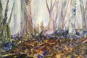 In Annie Broadley's painting 'Roots', bluebells grow in a woodland ravaged by a gale that broke branches, felled trees and wrenched roots from the ground