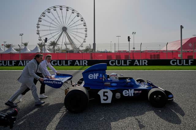 Former Formula One champion Jackie Stewart drives his original car before the Formula One Bahrain Grand Prix