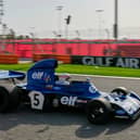 Former Formula One champion Jackie Stewart drives his original car before the Formula One Bahrain Grand Prix