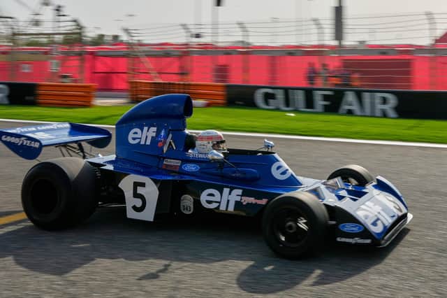 Former Formula One champion Jackie Stewart drives his original car before the Formula One Bahrain Grand Prix