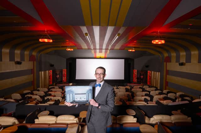Bruce Peter, author of 'Art Deco Scotland', at the Dominion Cinema in Edinburgh holding an archive photo of the cinema's interior. PIC: HES.