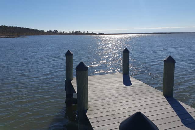 ... to the placid waters of Back Bay. And less than a mile of sand dunes apart.