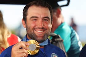 Team USA’s Scottie Scheffler shows off his gold medal after winning the men's individual event in the 2024 Olympic in Paris 