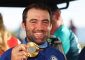 Team USA’s Scottie Scheffler shows off his gold medal after winning the men's individual event in the 2024 Olympic in Paris 