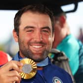 Team USA’s Scottie Scheffler shows off his gold medal after winning the men's individual event in the 2024 Olympic in Paris 