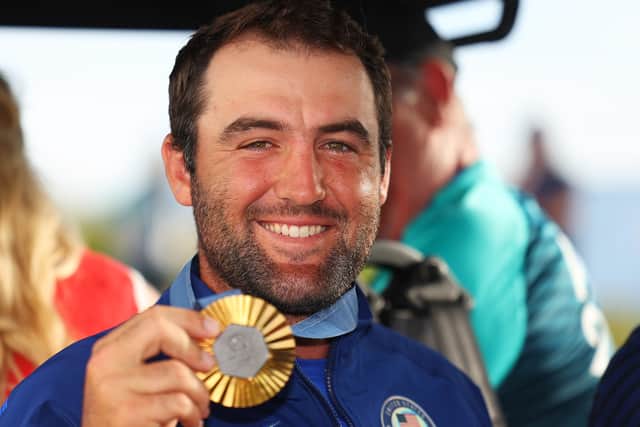 Team USA’s Scottie Scheffler shows off his gold medal after winning the men's individual event in the 2024 Olympic in Paris 