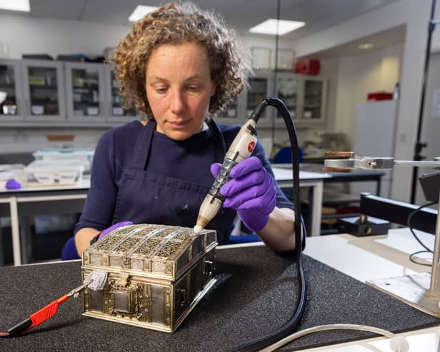 Conservator Diana de Bellaigue removes tarnish from the Mary, Queen of Scots casket. Copyright Duncan McGlynn