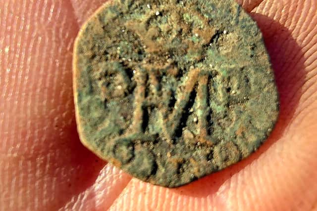 A 16th century coin from the period when Mary Queen of Scots was married to Francis II of France which  Mr MacPhee found with his metal detector on his croft on Benbecula 