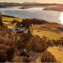 Kingsburgh House overlooking Loch Snizort on Skye. The house can be seen nestled in the trees in the foreground. PIC: Savills.