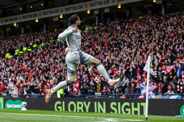 Oday Dabbagh celebrates in front of the gleeful Aberdeen fans after scoring the winning goal against Aberdeen.