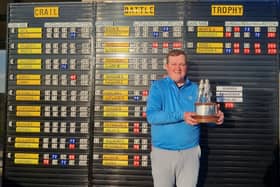 Host club member Andrew Davidson shows off the Battle Trophy after his win in the Crail Golfing Society event