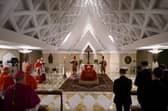 Handout photo provided by The Vatican of Pope Francis, who died on Easter Monday, lying in a wooden coffin dressed in red, with rosary beads draped across his hands