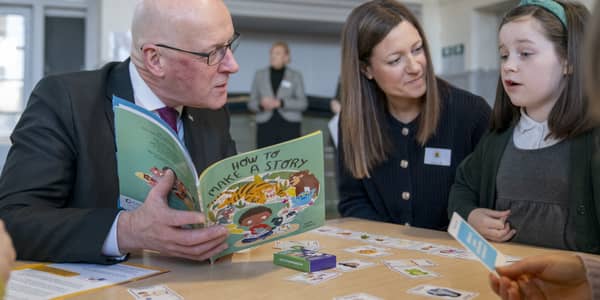John Swinney reads a book called 'How to Make a Story' during a visit to Edinburgh's Wardie Primary School (Picture: Jane Barlow)
