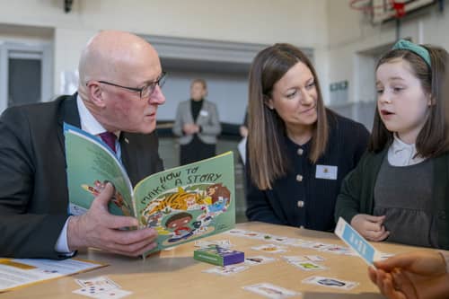 John Swinney reads a book called 'How to Make a Story' during a visit to Edinburgh's Wardie Primary School (Picture: Jane Barlow)