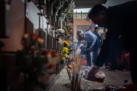 People place offerings on the graves of their ancestors during the annual Qingming festival, or Tomb Sweeping Day, at the United Chinese Cemetery in Macau on 4 April 2025.