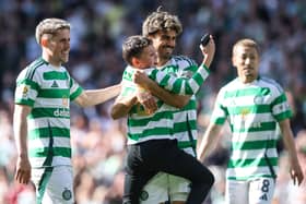 Jota celebrates his goal against St Johnstone in the Scottish Cup semi-final with a young fan. Cr: SNS Group.