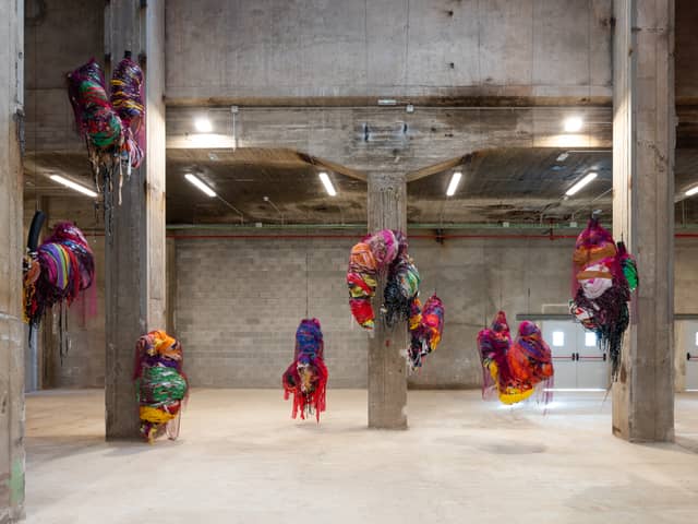 Nnena Kalu makes shapes out of paper and textiles which are then bound, layered and wrapped in brightly coloured cellophane and tape to create expressive hanging sculptural installations.