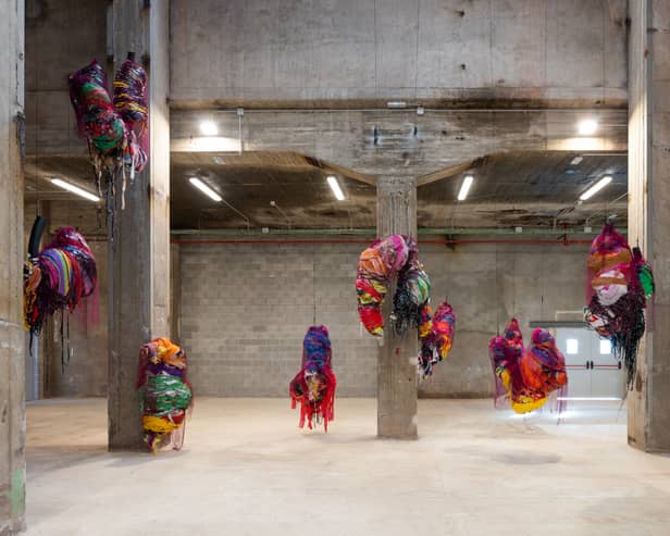 Nnena Kalu makes shapes out of paper and textiles which are then bound, layered and wrapped in brightly coloured cellophane and tape to create expressive hanging sculptural installations.