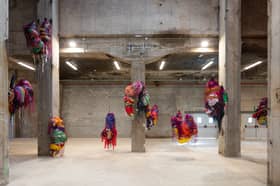 Nnena Kalu makes shapes out of paper and textiles which are then bound, layered and wrapped in brightly coloured cellophane and tape to create expressive hanging sculptural installations.