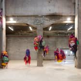 Nnena Kalu makes shapes out of paper and textiles which are then bound, layered and wrapped in brightly coloured cellophane and tape to create expressive hanging sculptural installations.