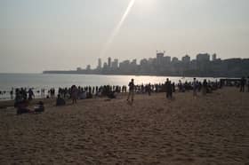 Families gather before sunset on Chowpatty beach in Mumbai