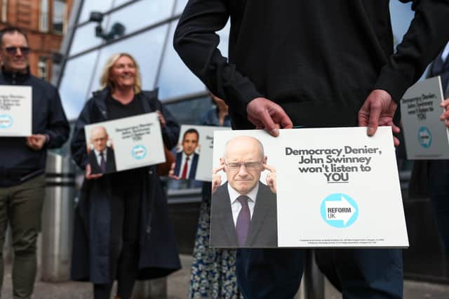 Reform UK activists protest outside the Merchants House of Glasgow where John Swinney convened an 'anti-far-right' summit on Wednesday (Picture: Jeff J Mitchell)