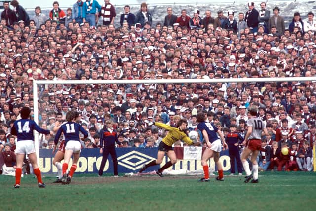 Dundee's Albert Kidd (left, 14) watches as Hearts 'keeper Henry Smith scrambles in vain to reach his shot