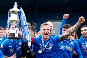 Peterhead captain Jason Brown lifts the William Hill League Two trophy following the win over East Fife at Balmoor Stadium/