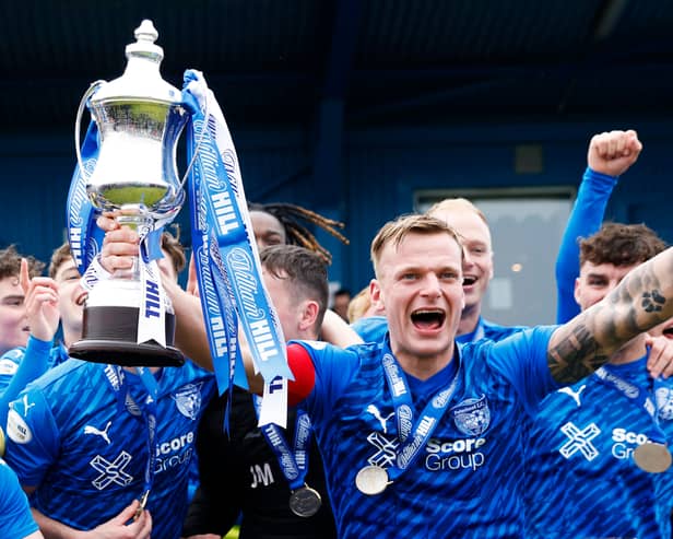 Peterhead captain Jason Brown lifts the William Hill League Two trophy following the win over East Fife at Balmoor Stadium/