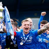 Peterhead captain Jason Brown lifts the William Hill League Two trophy following the win over East Fife at Balmoor Stadium/