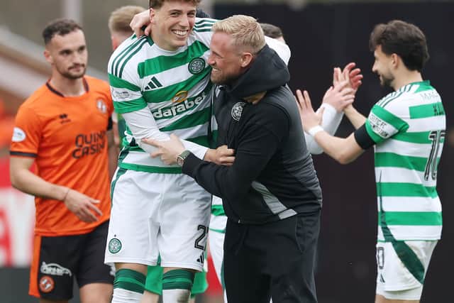Arne Engels of Celtic celebrates with injured Kasper Schmeichel at Tannadice
