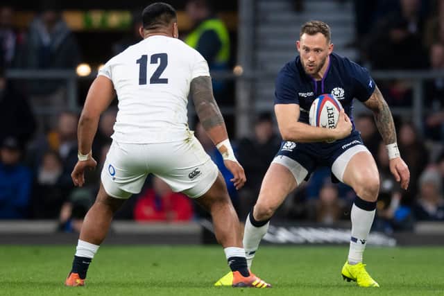 Scotland's Byron McGuigan takes on England's Manu Tuilagi at Twickenham in 2019.