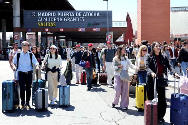 People leave the Atocha train station in Madrid after its closure as a massive power outage hits Spain. Picture: Thomas Coex/AFP via Getty Images