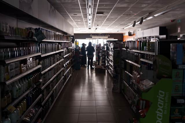 Employees stand inside a supermarket without lights in Burgos. Picture: Cesar Manso/AFP via Getty Images