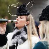 A racegoer drinks Champagne from a novel kind of flute at the Cheltenham Festival (Picture: Mike Egerton)